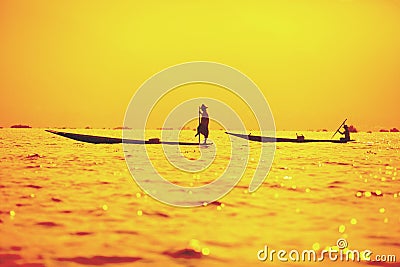 Fishermen at dawn catching fish on Inle Lake Stock Photo