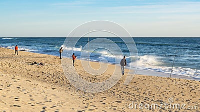 Fishermen fishing on beach at Faro, Algarve, Portugal. Editorial Stock Photo