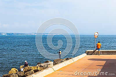 Fishermen fishing in Oeiras, Portugal Editorial Stock Photo