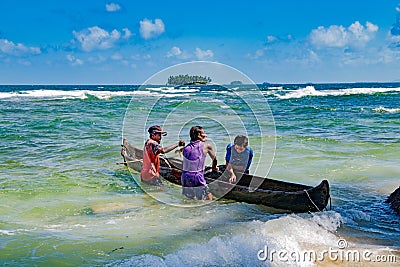 Fishermen holding dugout to fetch out lobsters and crabs on small island in Caribbean Sea Editorial Stock Photo