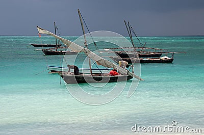 Fishermen in the Indian Ocean are folded sail on a boat before the storm. A flotilla of traditional fishing boats, dhow on the wav Editorial Stock Photo