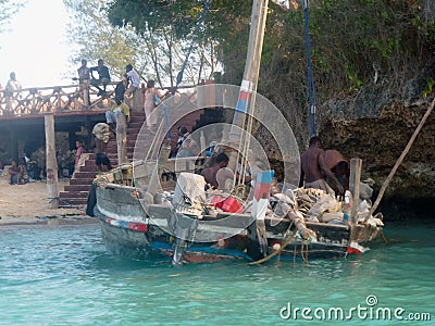 Fishermen near the shore prepare their wooden boat boat for swimming and fishing. Lifestyle of marine life of poor countries Editorial Stock Photo