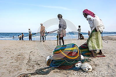 Fishermen pull in their fishing nets on the beach at Uppuveli in Sri Lanka. Editorial Stock Photo