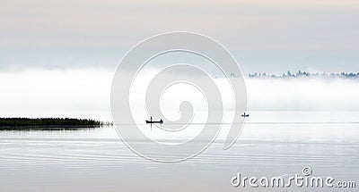 Misty autumn morning. Fishermen on the river in a boat. Peace and quiet Stock Photo