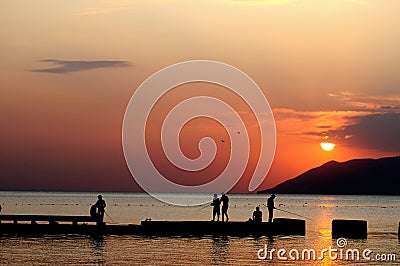 Fishermen at sunset Stock Photo
