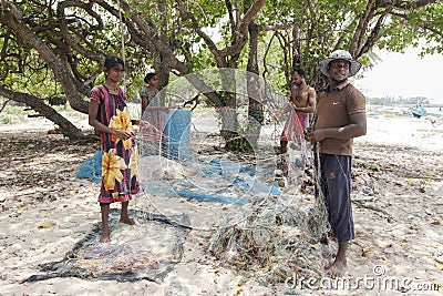 Fishermen and women preparing their fishing nets on Delft Island in the northern region of Jaffna in Sri Lanka. Editorial Stock Photo
