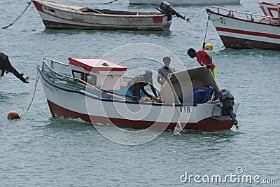 Fishermen working on a boat in Sal rei, Cabo Verde Editorial Stock Photo