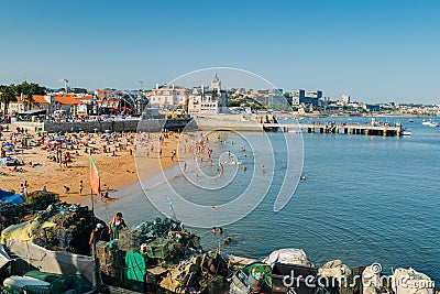 Fishermen working on rusty fishing traps, made of iron bars and green nylon nets, piled up on a dock a pier in Cascais, Portugal Editorial Stock Photo