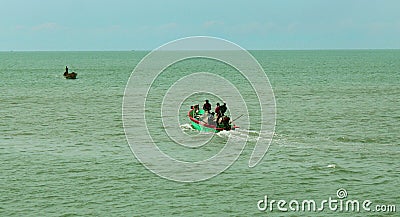 Fishermen at works on the wooden motor boat. Editorial Stock Photo