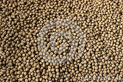 Fishery feed for fish feed. Fish feed pellets, close up of granulated fish food texture Stock Photo