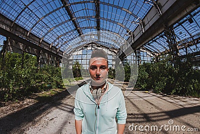 Fisheye portrait of short hair girl in an abandoned factory Stock Photo