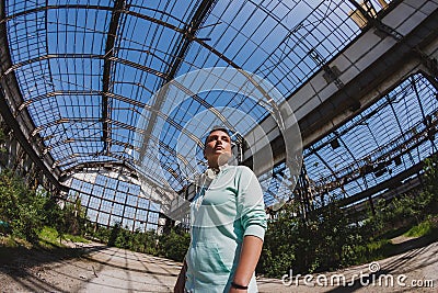 Fisheye portrait of short hair girl in an abandoned factory Stock Photo