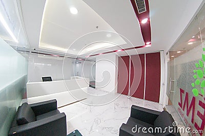 Fisheye shot of modern office with white walls and red inserts Editorial Stock Photo