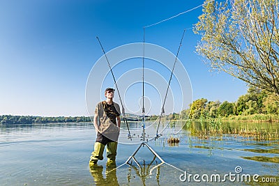 Fishing adventures, carp fishing. Fisherman and carpfishing gear Stock Photo