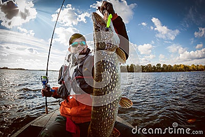 Fisherman and big trophy Pike. Stock Photo