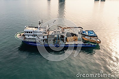 Fishing boat aerial view from drone on sea surface. Fishing and seafood industry Editorial Stock Photo