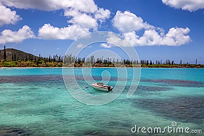 Fishing boat anchored by coast of Isle of Pines Stock Photo