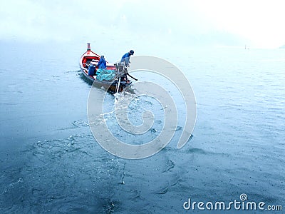 Fishing boat in blue lake Stock Photo