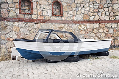 A fishing boat on the car wheels in the street in Bodrum, Turkey Stock Photo