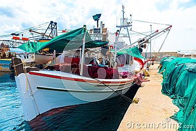 Fishing boat with colorful nets at the dock Stock Photo