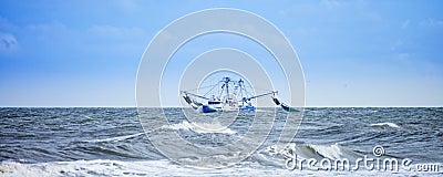 Fishing boat fishing in rough seas Stock Photo