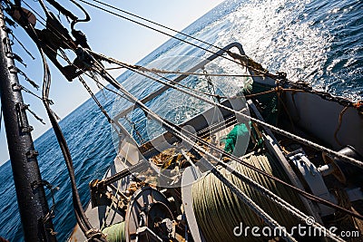 Fishing boat fishing by trawl in coastal waters Stock Photo