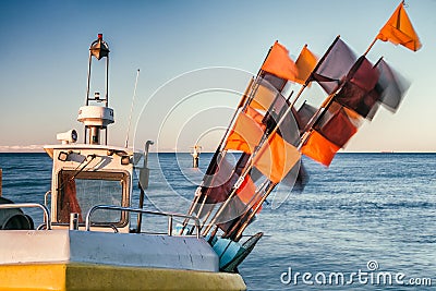 Fishing boat with flags close view Stock Photo