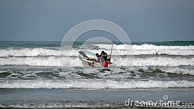 Fishing boat launching from the beach Editorial Stock Photo