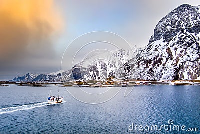Fishing boat in Norway Lofoten aerial landscape in winter time with rainbow and mountains covered in snow Editorial Stock Photo