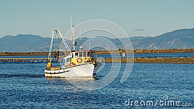 A fishing boat returning to Port Motueka Editorial Stock Photo