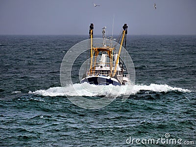 Fishing Boat in Rough Weather. Stock Photo