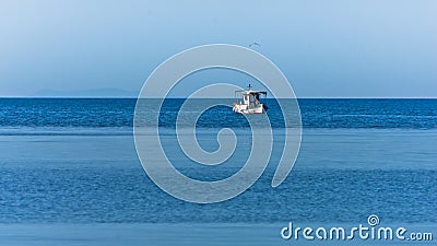 Fishing boat at sea on a sunny morning in Sithonia Stock Photo