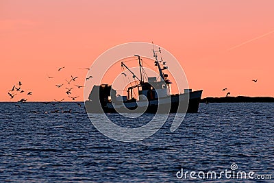 Fishing boat in silhouette Stock Photo