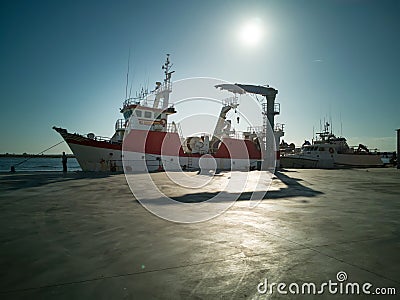 Fishing boat in a Spanish harbor. Front view backlight maritime scene Editorial Stock Photo