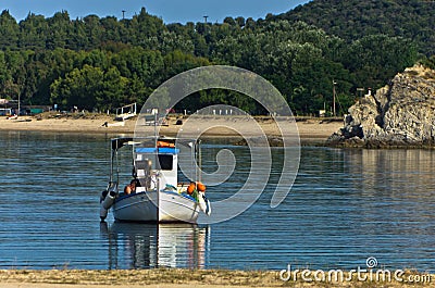 Fishing boat at sunny morning in front of Destenika beach Stock Photo