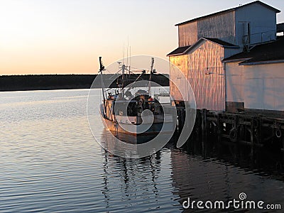 Fishing boat at sunset Stock Photo