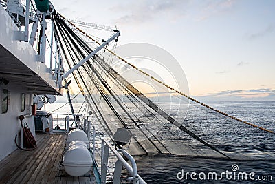 Fishing boat fishing for tuna fish during sunrise. Fishing operation Stock Photo