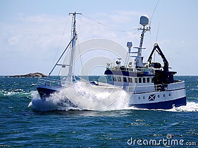 Fishing Boat Underway at Speed Breaking Wave. Editorial Stock Photo