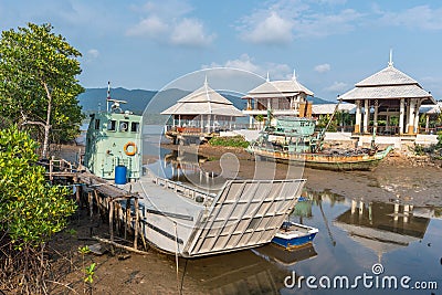 Fishing boats and ferry moored on the coast in Fishing Village Editorial Stock Photo