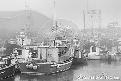 Fishing boats in foggy harbor of Saint Bride`s Editorial Stock Photo