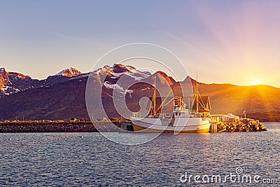 Fishing boats in harbor at midnight sun in Northern Norway, Lofoten Island, Ramberg, Norway Stock Photo