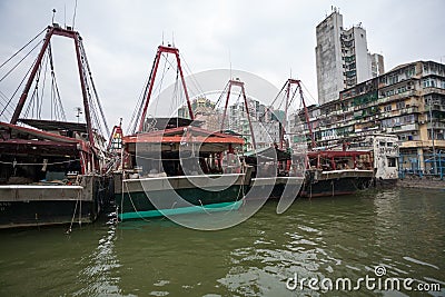 Fishing boats are at the pier at the fishing port in Macau. Stock Photo