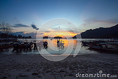 Fishing boats resting on a beach Stock Photo