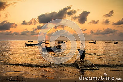 Fishing boats, small boats floating in the sea at sunrise, Concept sea in the morning. Stock Photo