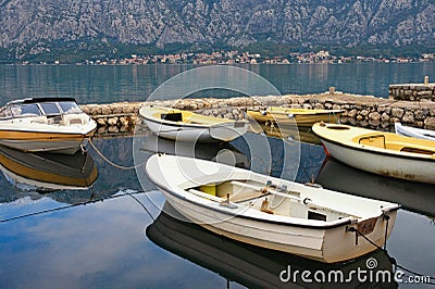 Fishing boats in small harbor, autumn. Montenegro, Bay of Kotor near Prcanj town Stock Photo