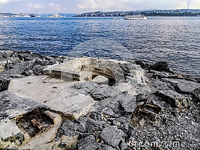 Fishing buildings on the embankment of the Bosporus in Istanbul Turkey. Homemade picnic and relaxation area among large granite Stock Photo