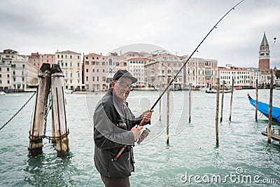 Fishing by Canal Grande in Venice Editorial Stock Photo