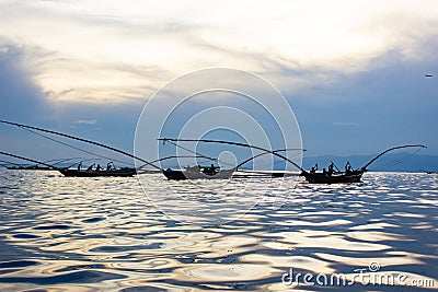 Fishermen on Lake Kivu, Rwanda - Sunset reflection on water Stock Photo