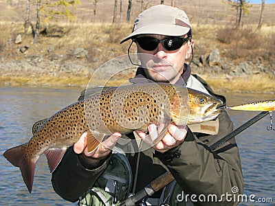 Fishing - fisherman with big trout Stock Photo