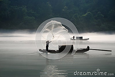 Fishing in the fog river Stock Photo